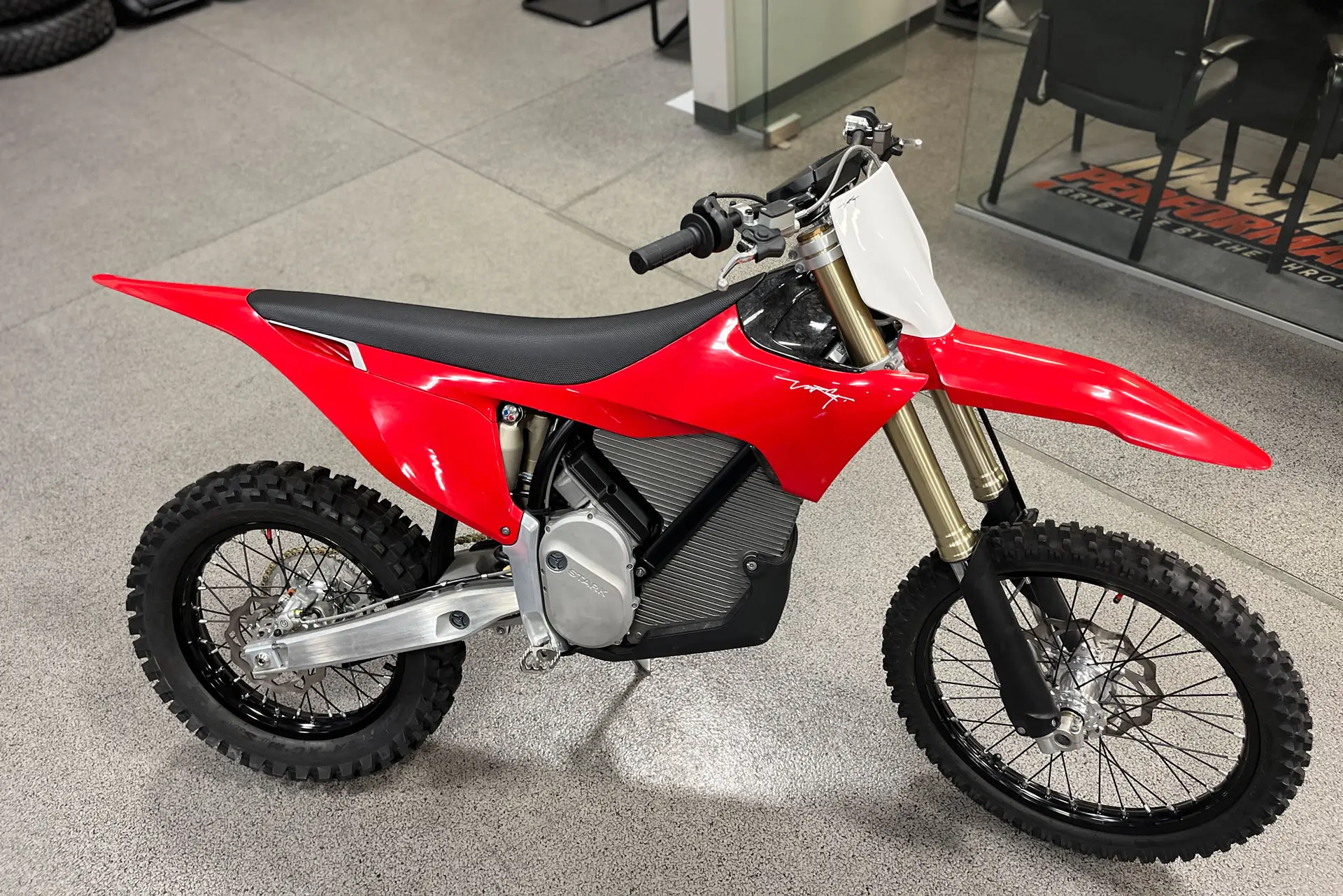 The VARG motocross bike from Stark Future stands in a showroom,
